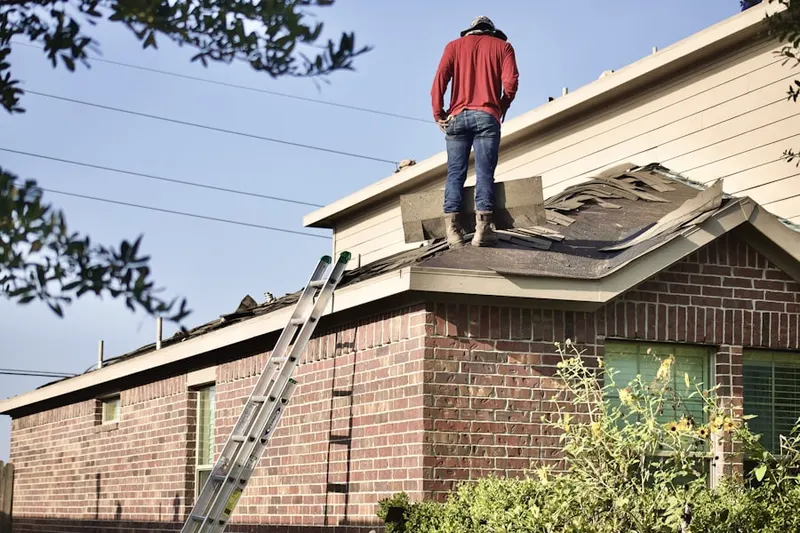 Professional roofer working on a residential roof in Wyoming Meadows